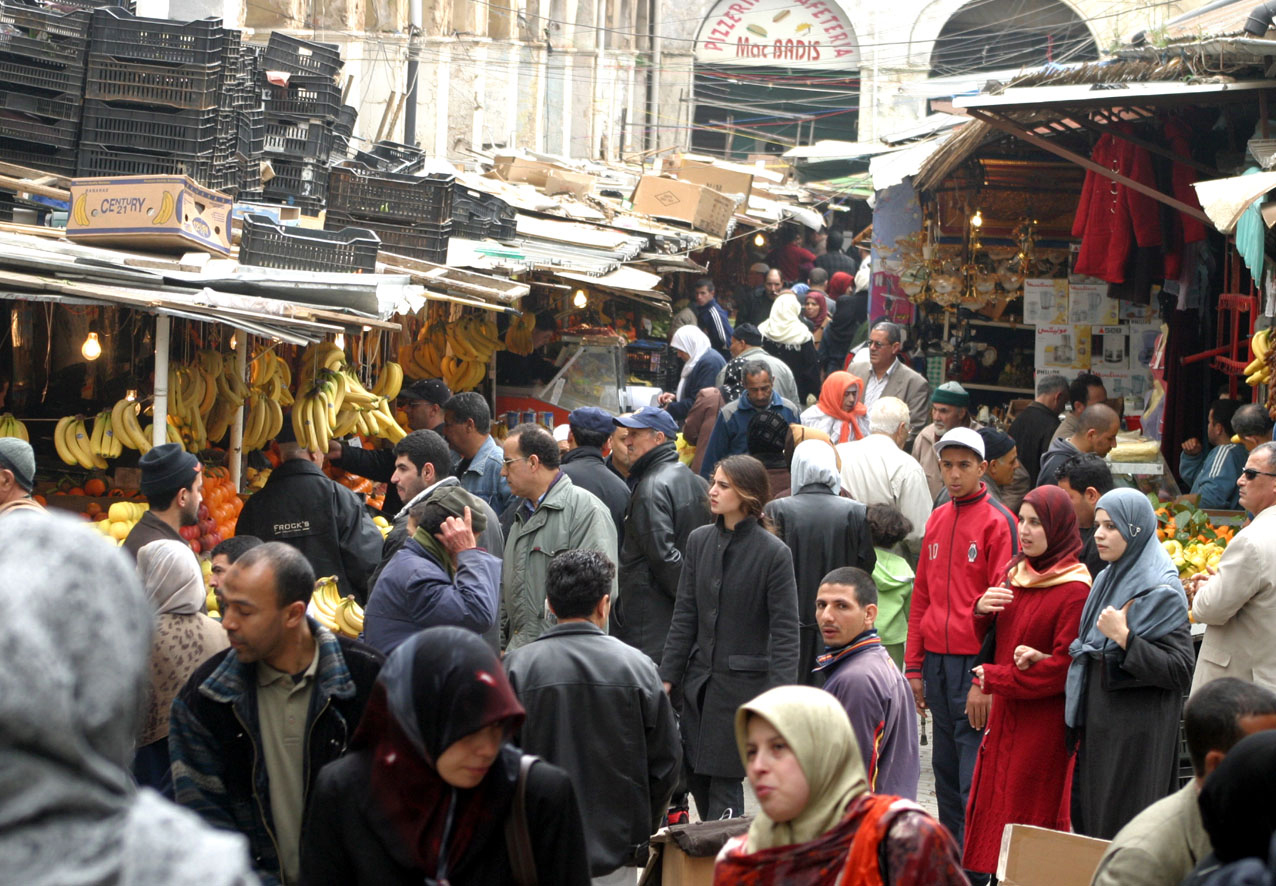 Customers and sellers at a produce market in Algeria in an archival photograph
