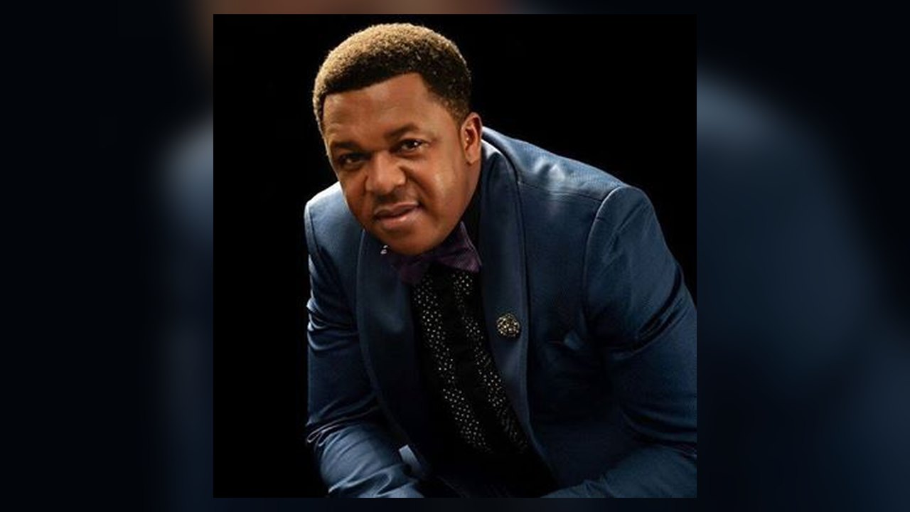 Archival studio portrait of Nigerian actor Francis Duru wearing a dark blue suit in Abuja in 2020
