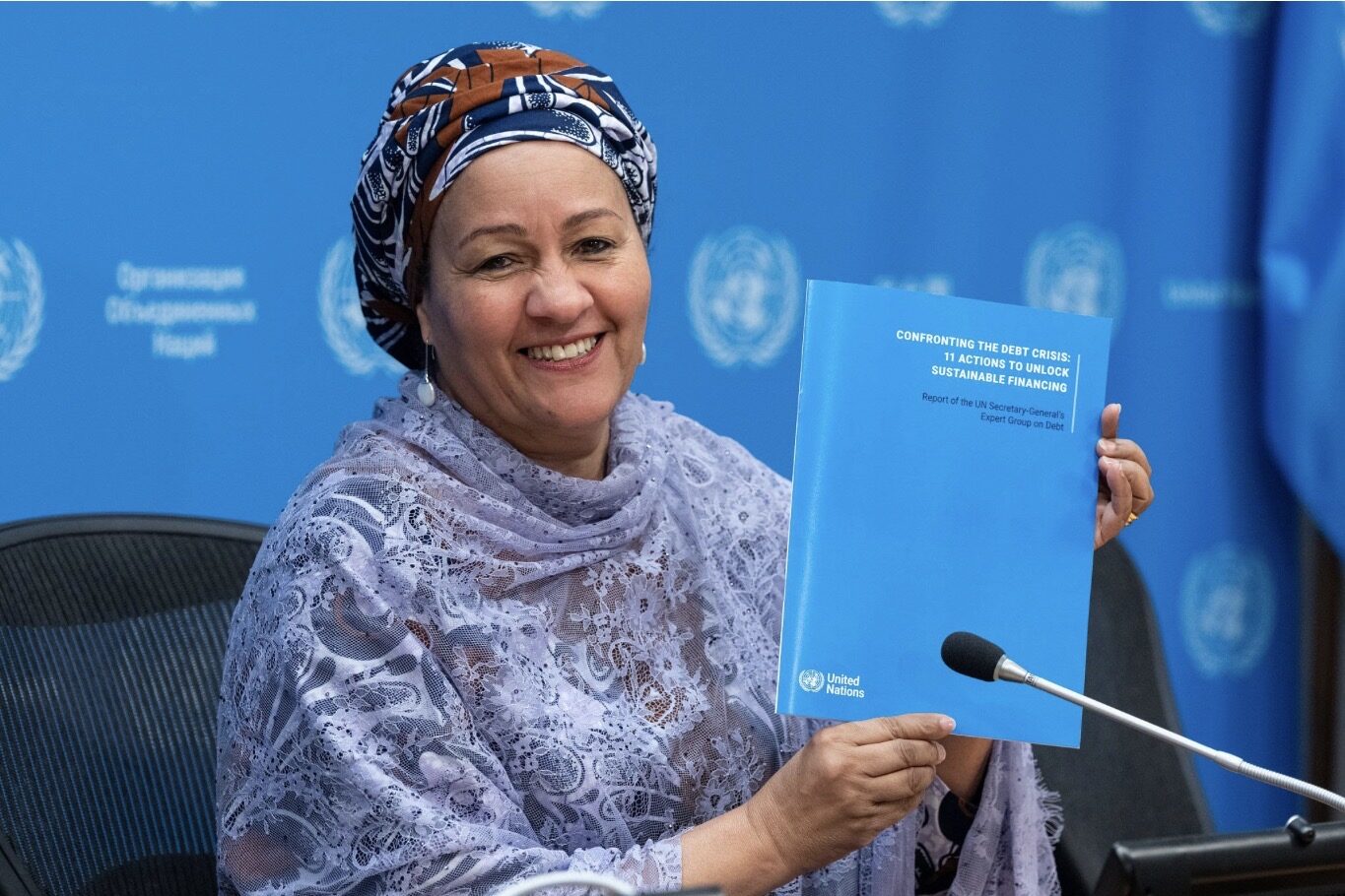 United Nations Deputy Secretary-General Amina J. Mohammed holding the UN expert group report Confronting the Debt Crisis