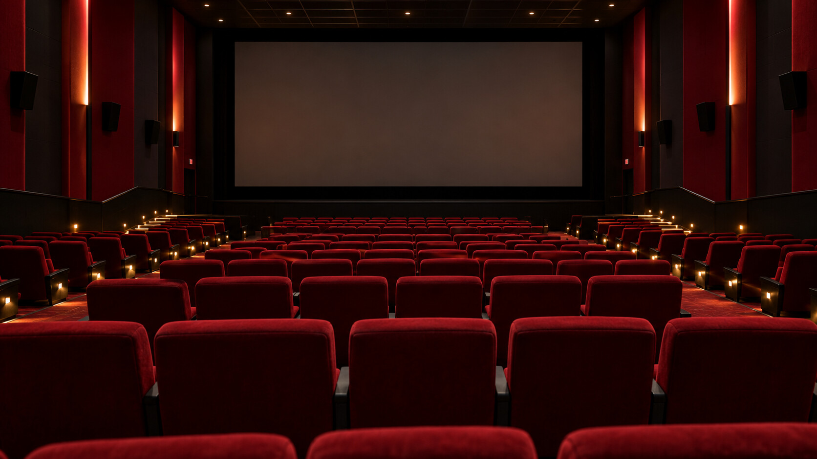 Orderly deep-red seats in an empty imagined cinema with a blank screen and softly lit aisles