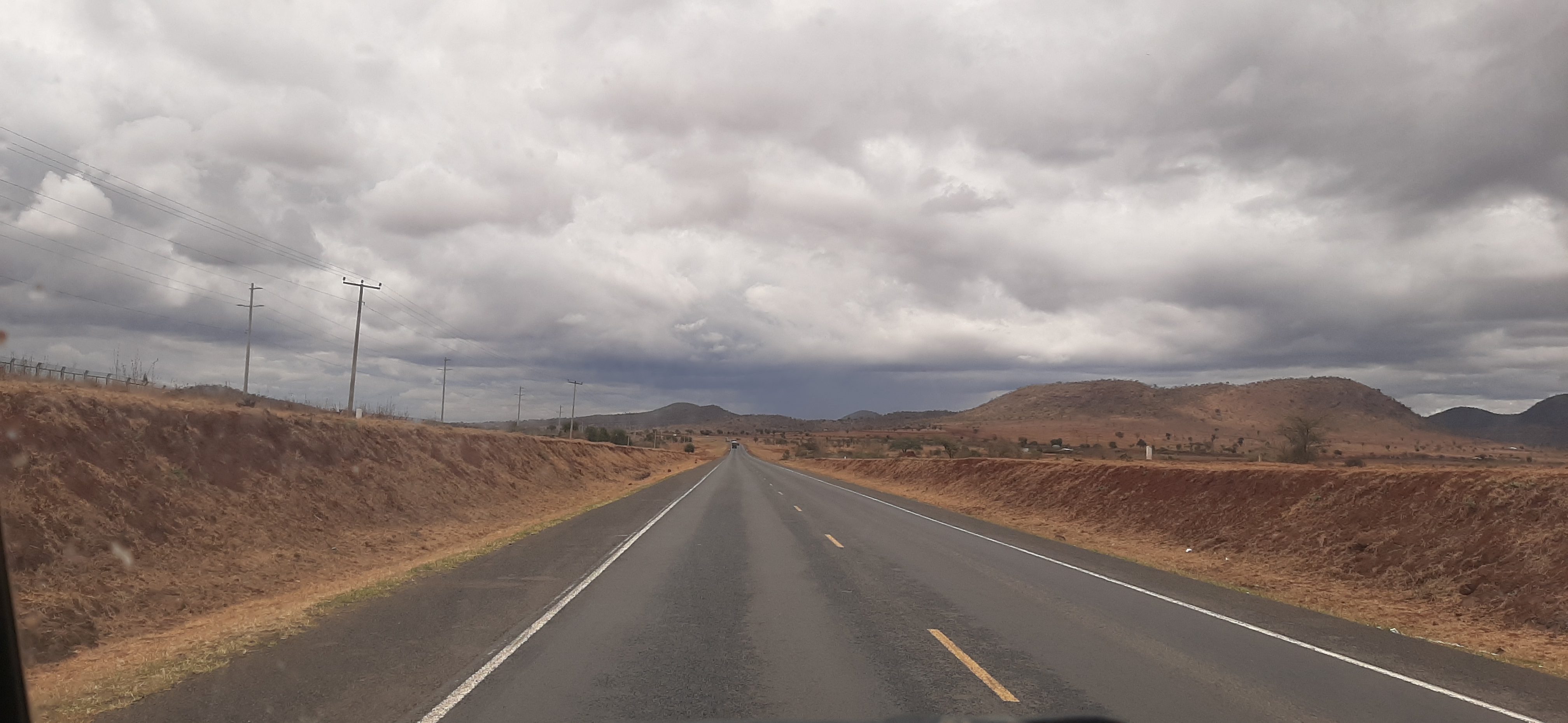Vehicles travelling on the Nairobi–Mombasa highway through the Kenyan landscape in September 2019