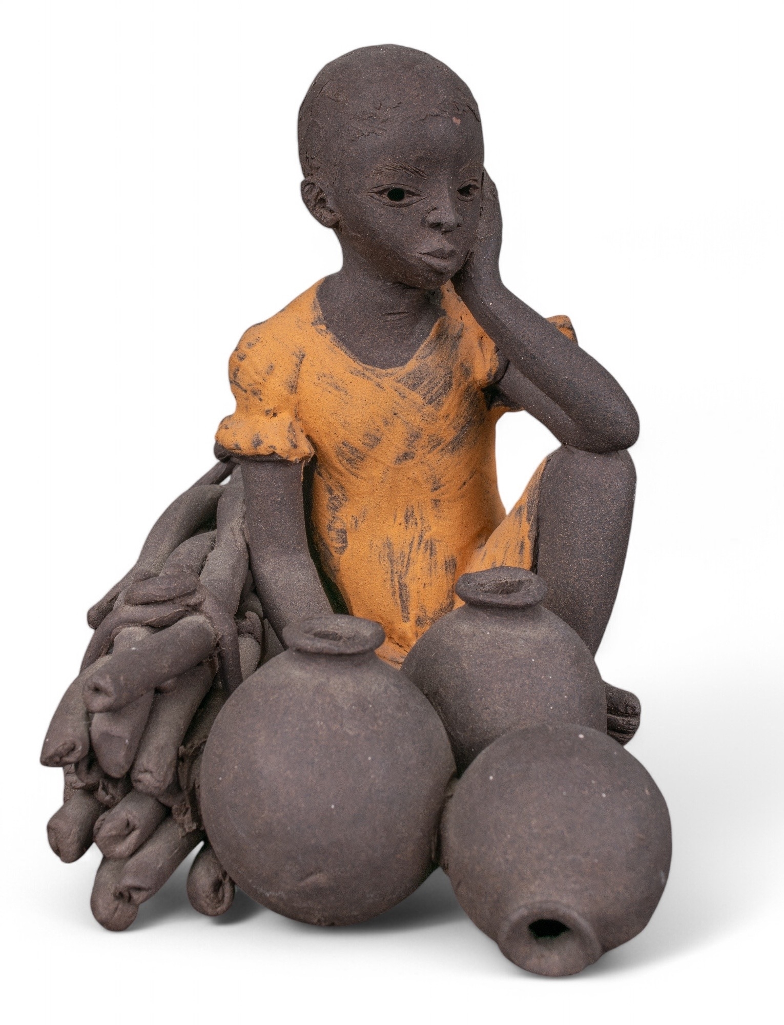 Painted terracotta figure of a seated child beside vessels and produce