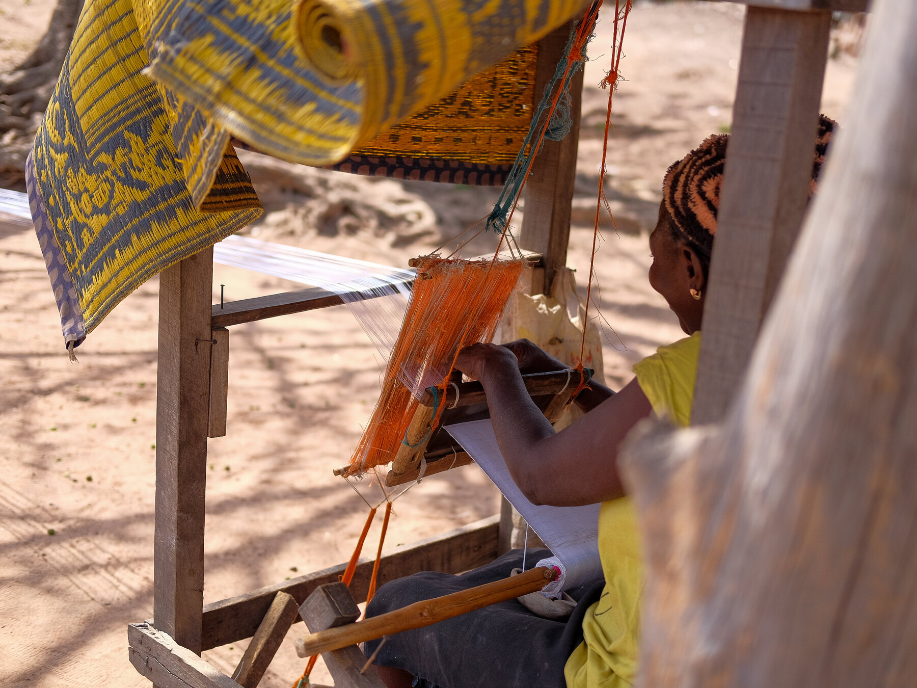 A weaver working at an aso oke loom in Nigeria
