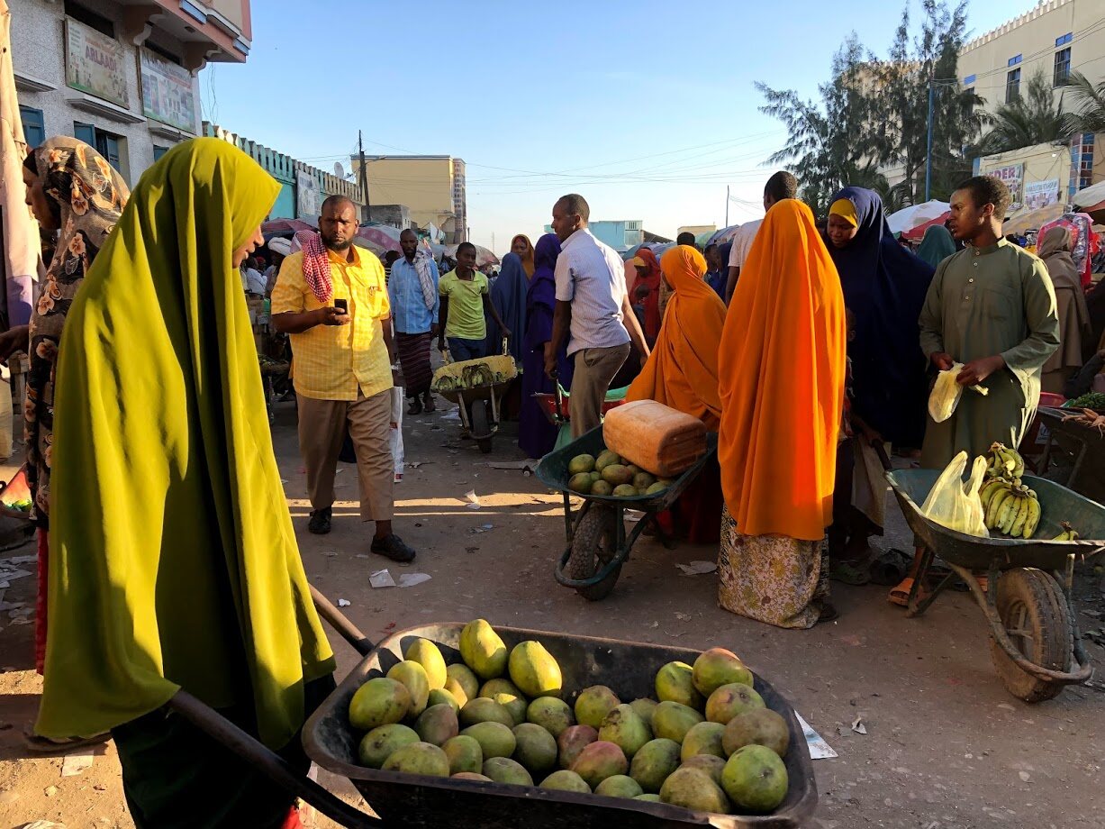 People buying and selling fruit in Baidoa market, Somalia