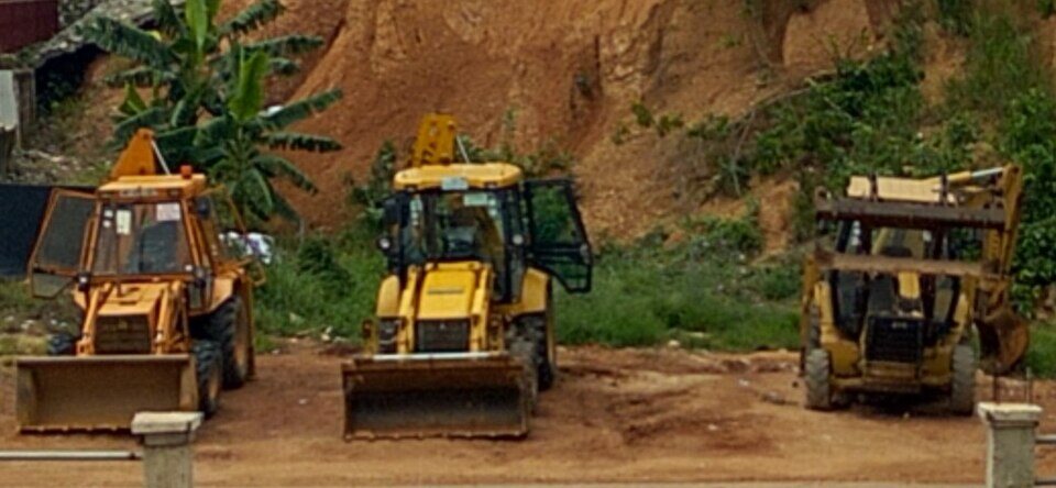 Earth-moving equipment at a galamsey mining site in Ghana
